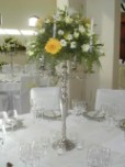 Silver candelabra, flower arrangement as guest table centrepiece